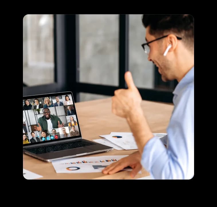 Team member on a Zoiko Sema video call giving a thumbs up, with meeting participants visible on a laptop screen