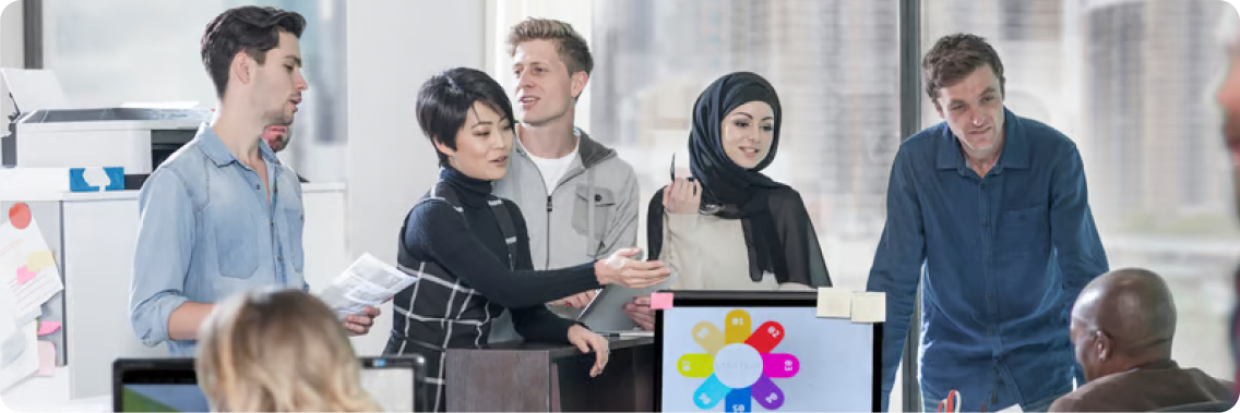A diverse team collaborating around integration options in a bright office